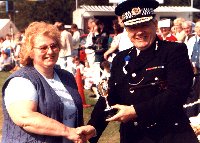 Jean West receiving cup for community service
