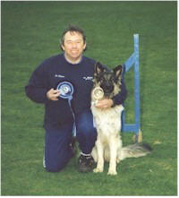 Jim Gregson shows off his rosette and his Shepherd